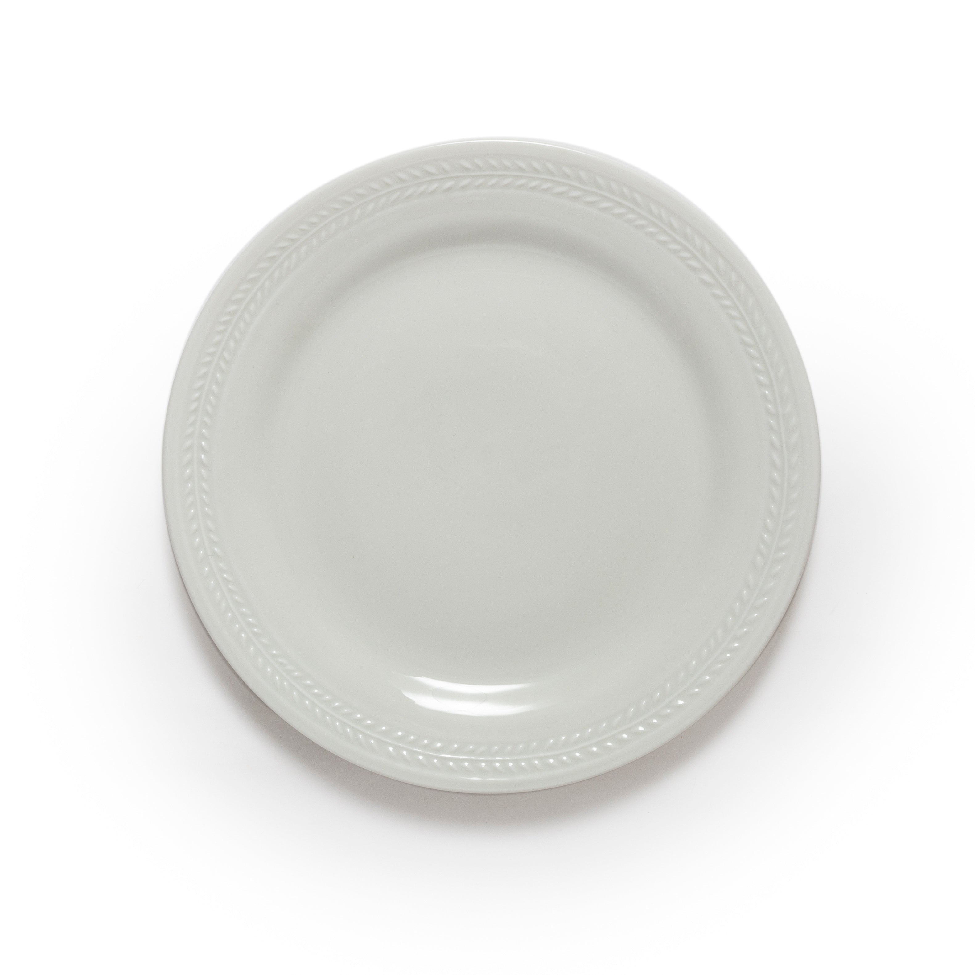 White ceramic plate with decorative edge on a white background