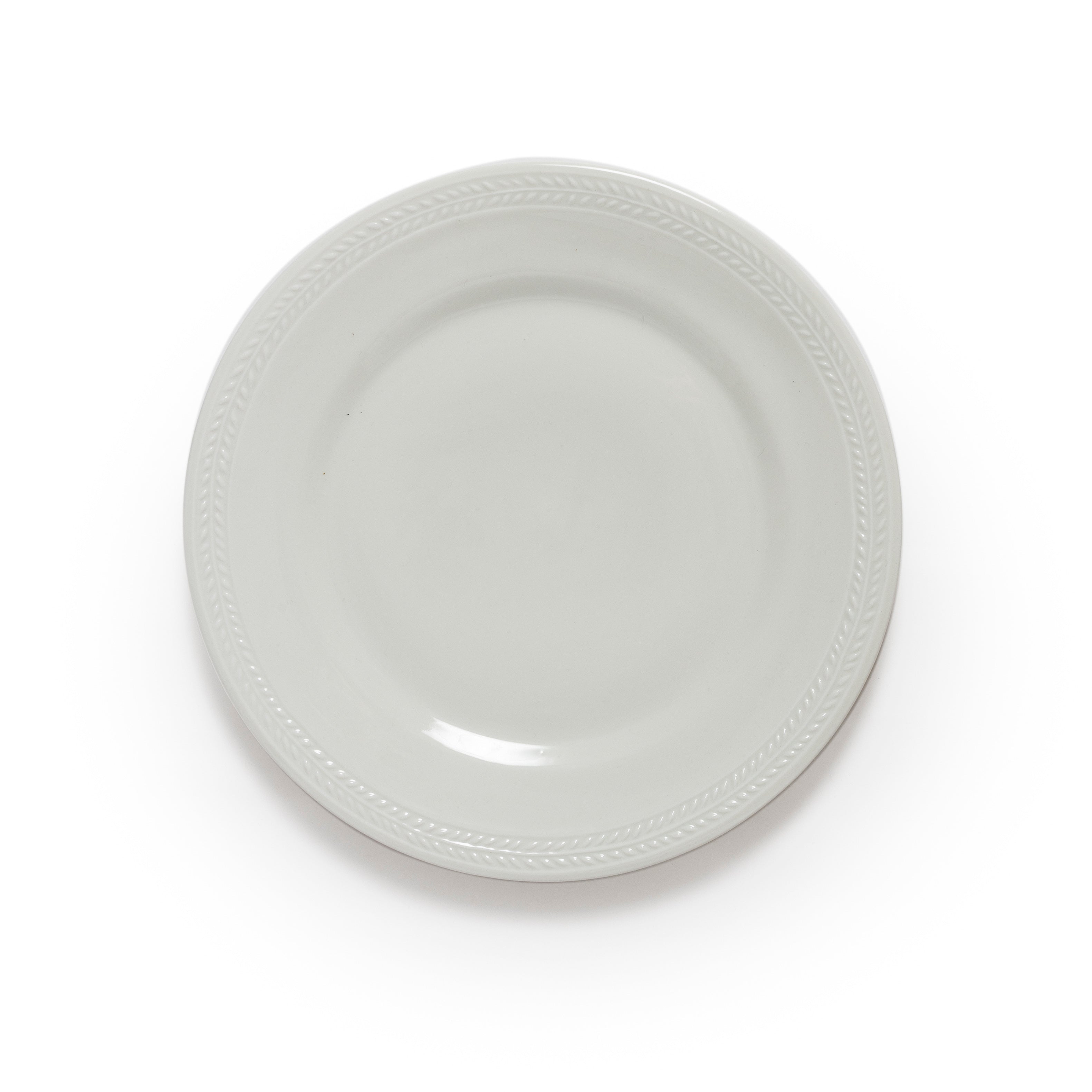 White ceramic plate with decorative rim on a white background