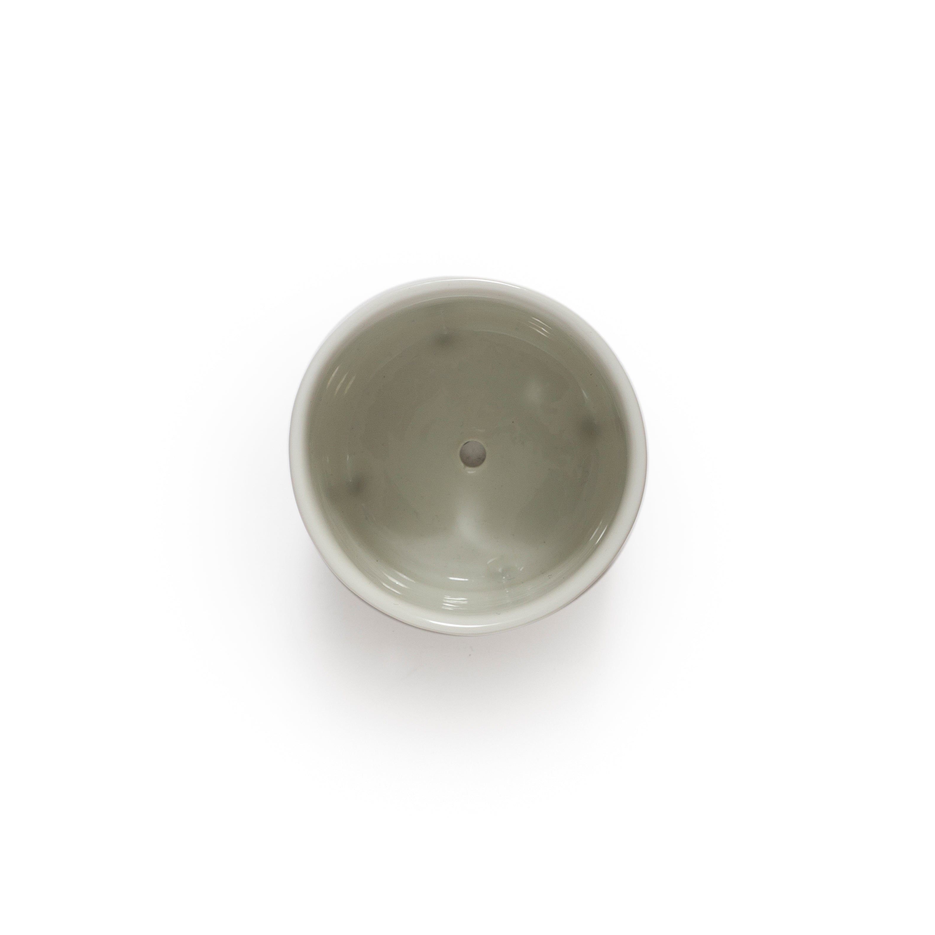 White ceramic jar with small holes on a white background
