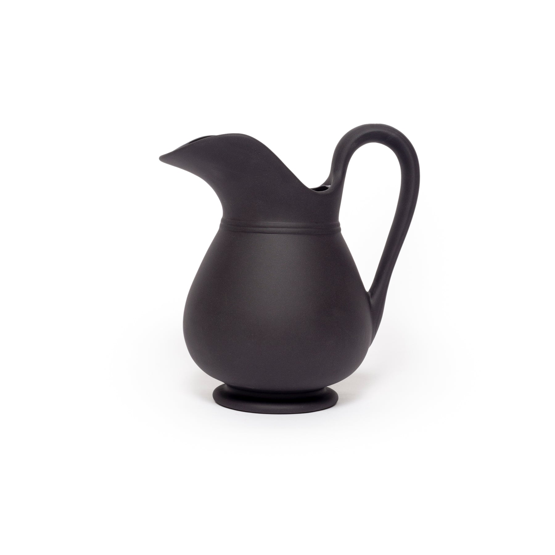 Black ceramic pitcher on a white background