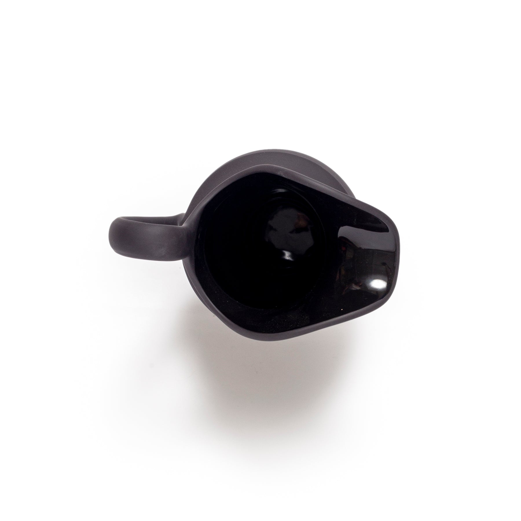 Black ceramic pitcher on a white background