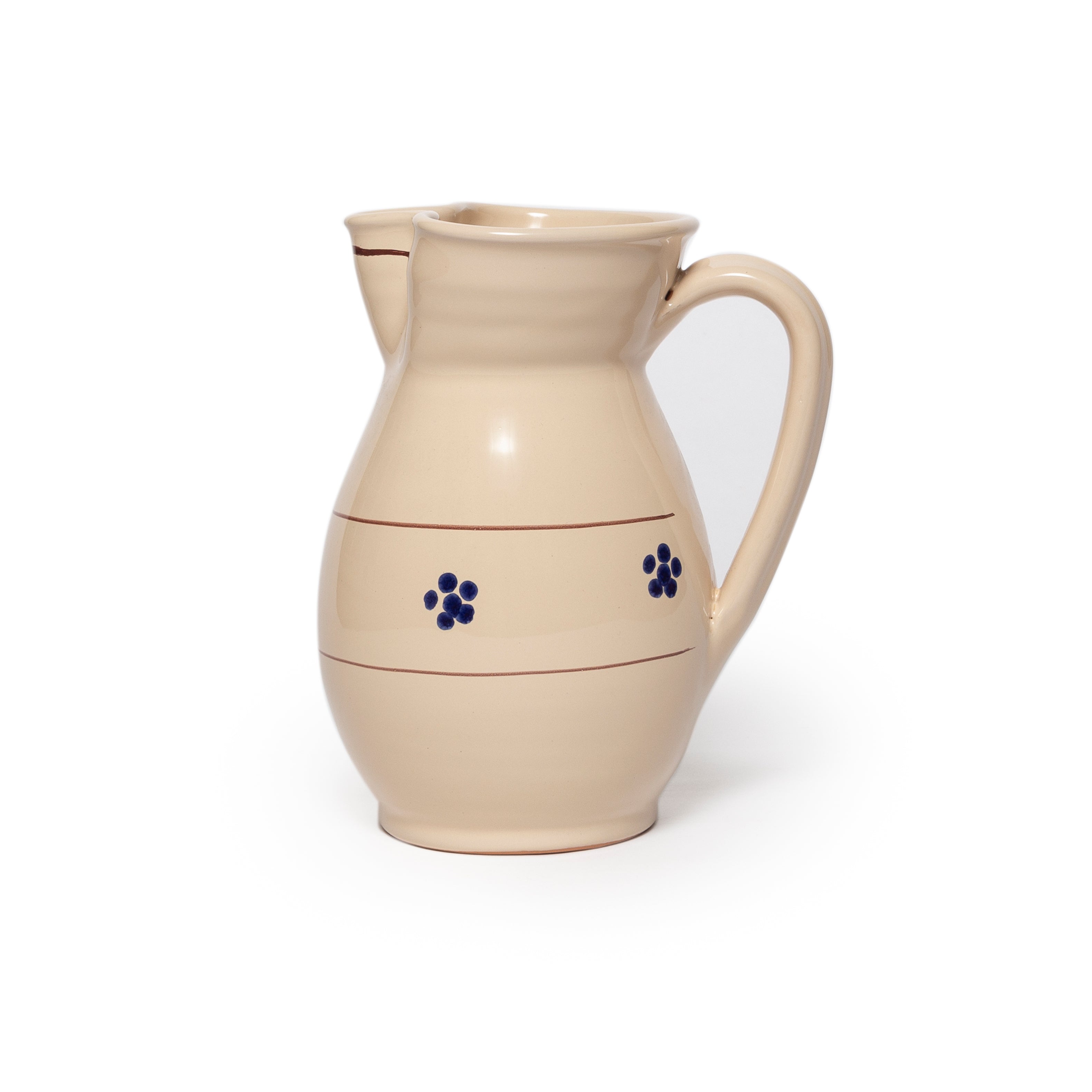 Beige ceramic pitcher with blue flowers on a white background