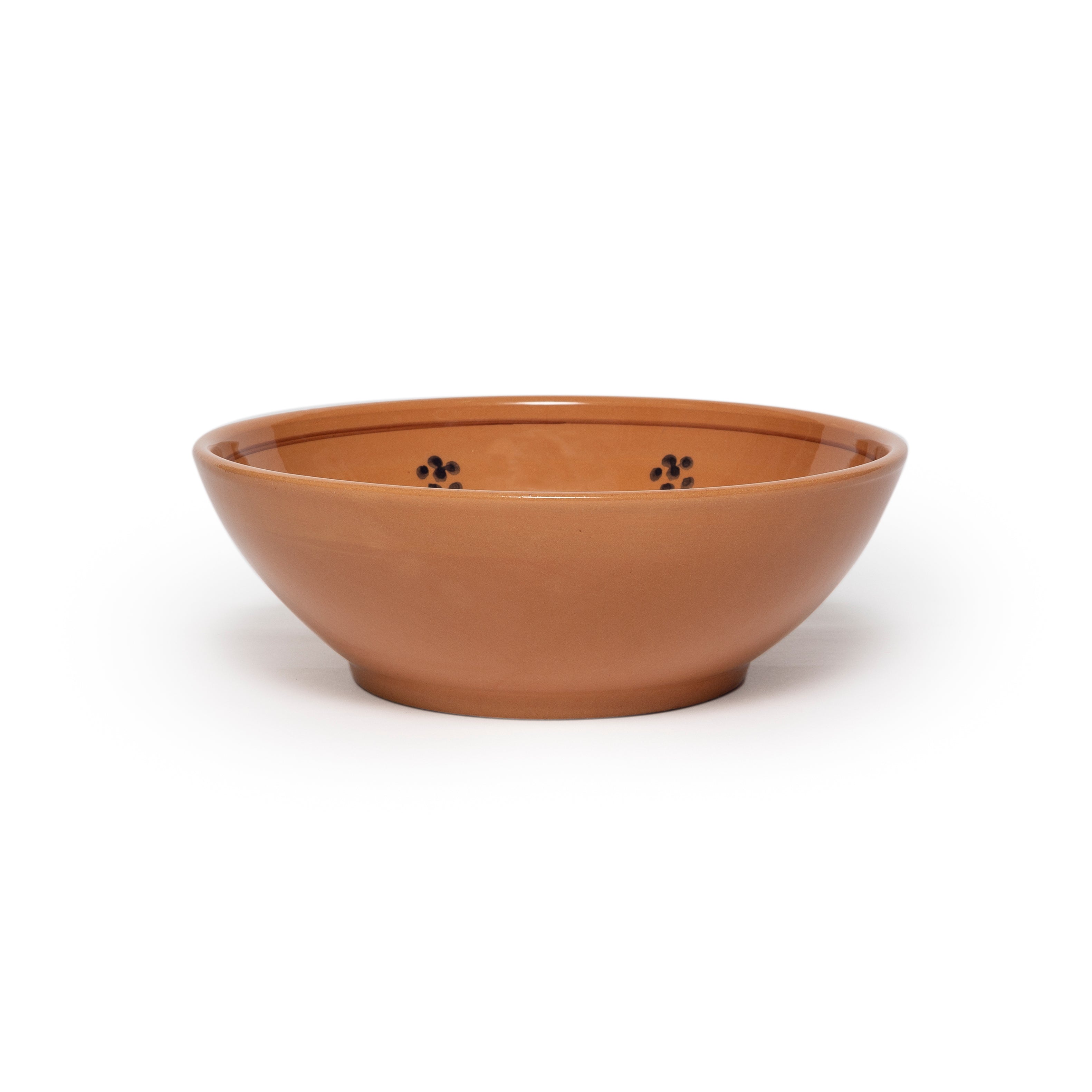 Brown ceramic bowl with flowers on a white background