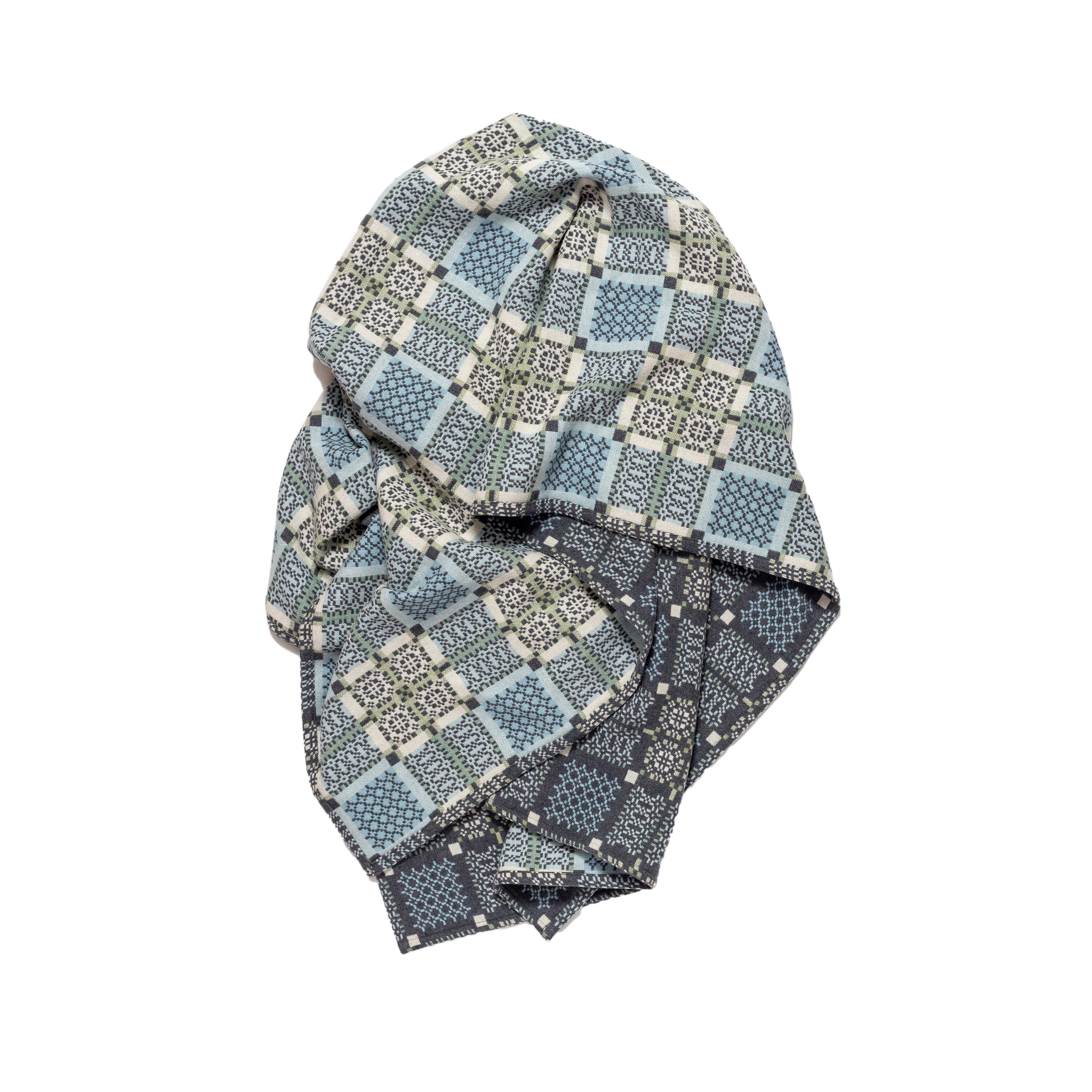 Folded patterned fabric on a white background