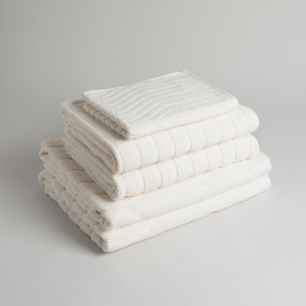 Stack of folded Baina Ivory towels