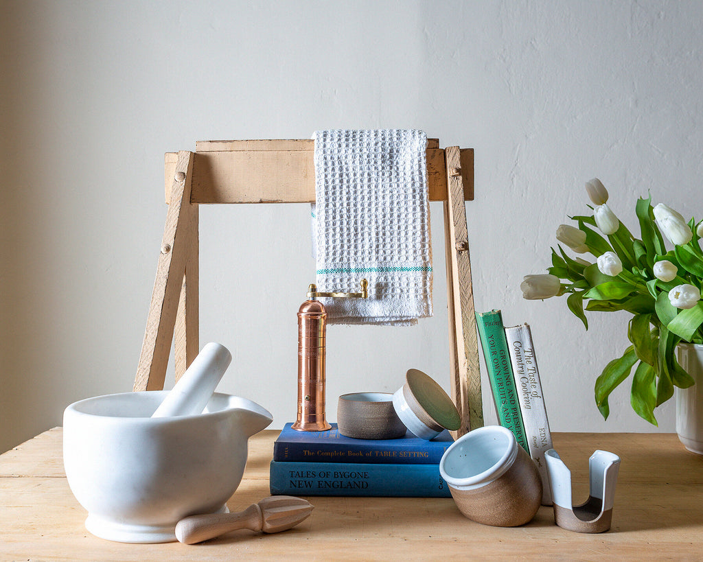 Kitchen utensils and books on table
