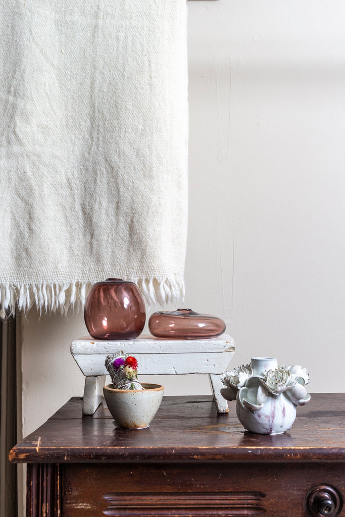 Auntie Oti Rustic Wool Blanket behind a set of vases